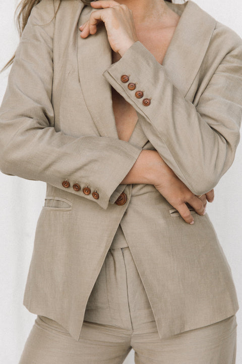 Close-up of brown corozo buttons on a taupe blazer